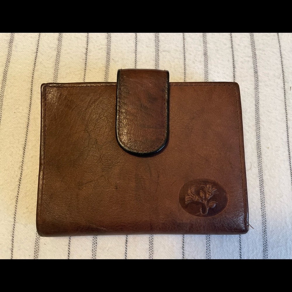 Buxton women’s top grain cowhide leather , floral embossed.